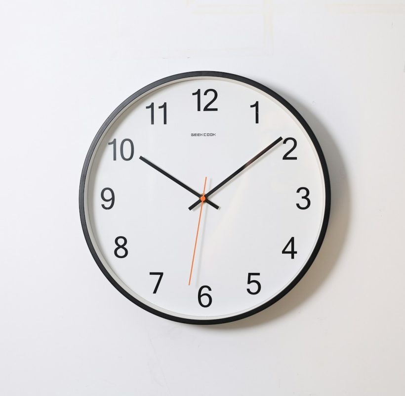 round analog wall clock pointing at 10:09